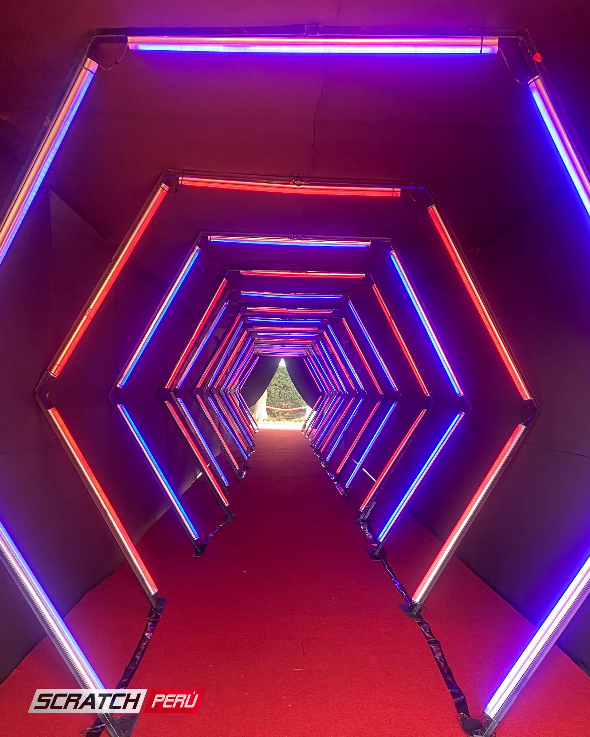 Túnel LED hexagonal rojo y azul: Iluminación llamativa en un pasillo destacado, añadiendo un toque de estilo. - Túnel hexagonal led - scratch perú.