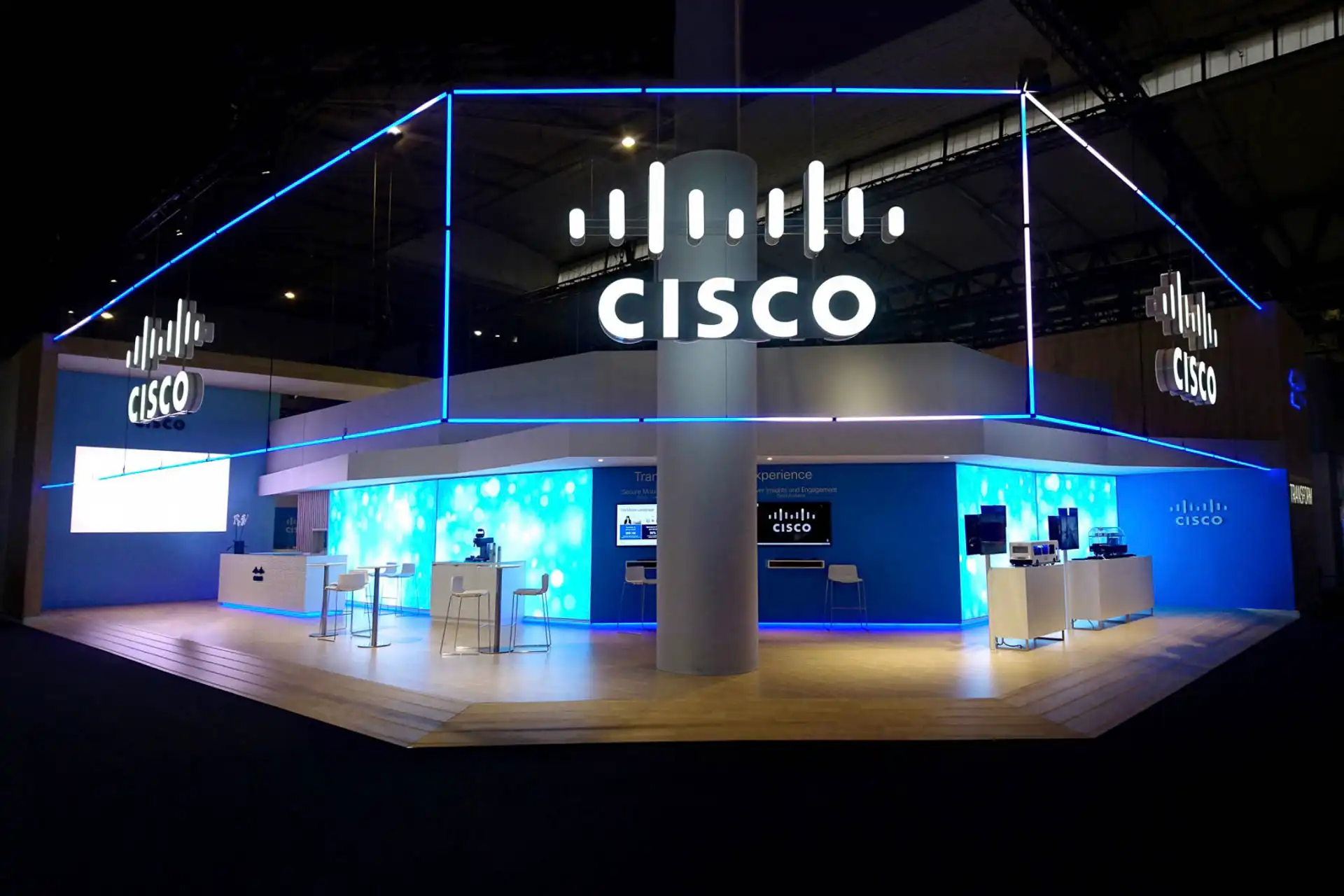 Diseño del stand de Cisco en una feria tecnológica, utilizando tubos LED RGB 360 grados controlados por ArtNet. La iluminación azul realza el logotipo y la estructura, captando la atención de los visitantes.